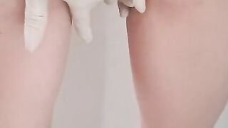 Blonde solo masturbating inside latex gloves..