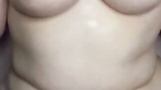 chubby Women oils up her tits and plays with them