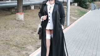 Slut walking into the park into a raincoat and ebony fishnet stockings with a white elastic band