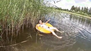 Having Fun with a Water Donut Naked in the Lake